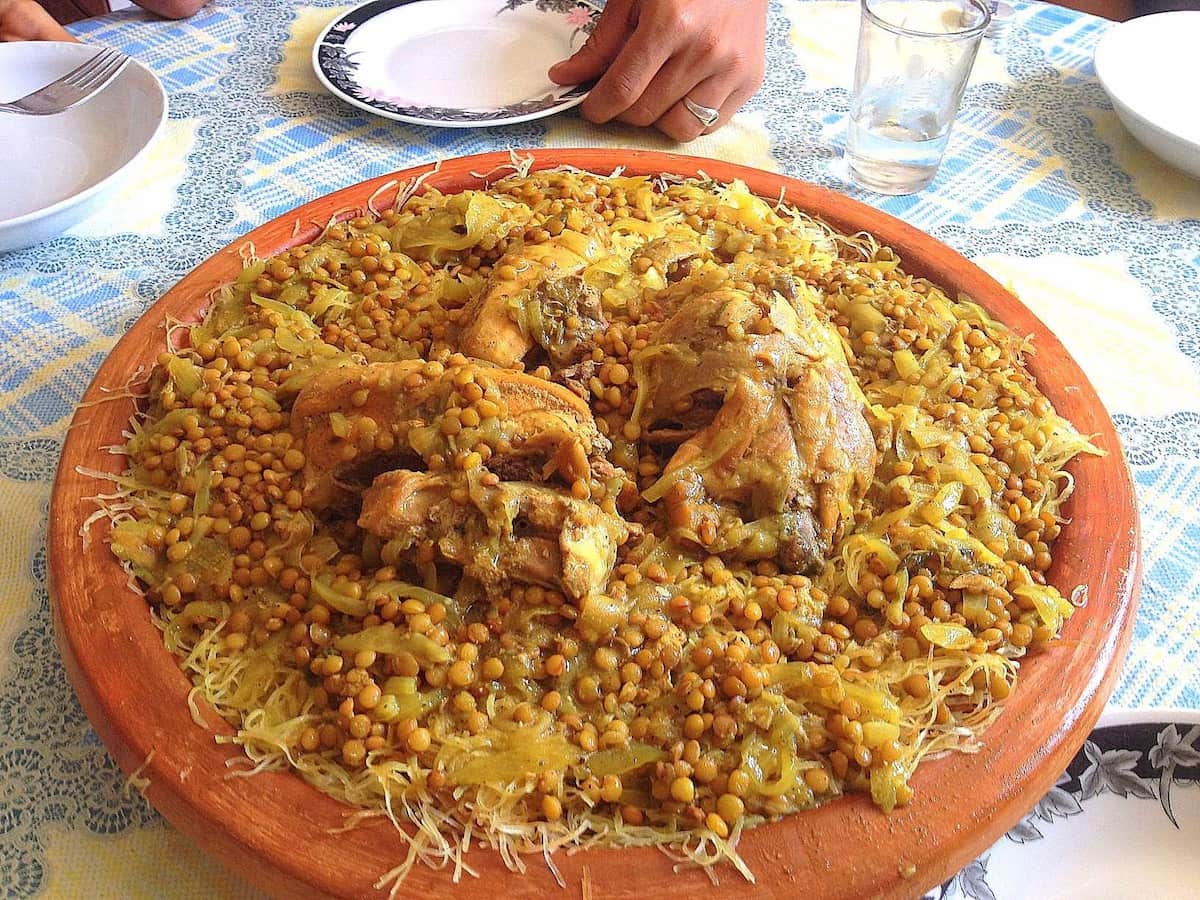 Traditional Moroccan rfissa with chicken, lentils, and shredded msemen bread served in a clay dish