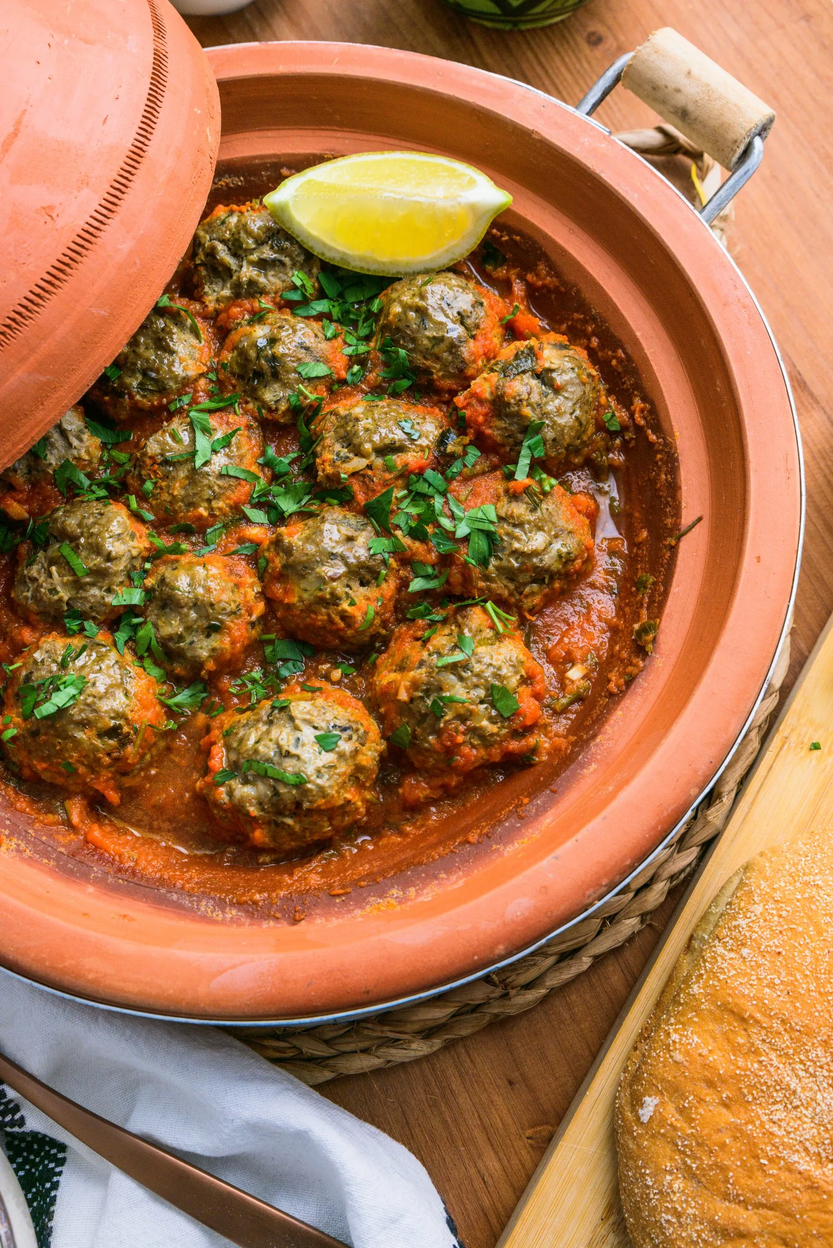 Authentic Moroccan Sardine Balls in Tomato Sauce (Kefta dyal Hout) served in a traditional tagine with fresh herbs and homemade tomato sauce.