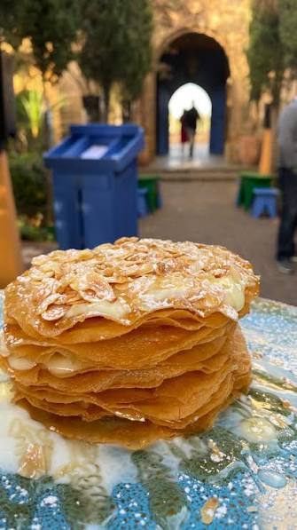 Moroccan Jawhara dessert with crispy pastry, milk cream and toasted almonds